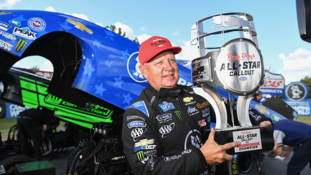 Robert Hight celebrates with the massive winner's trophy after capturing the Pep Boys NHRA Funny Car Callout Sunday at Lucas Oil Raceway in suburban Indianapolis. Photo courtesy NHRA.